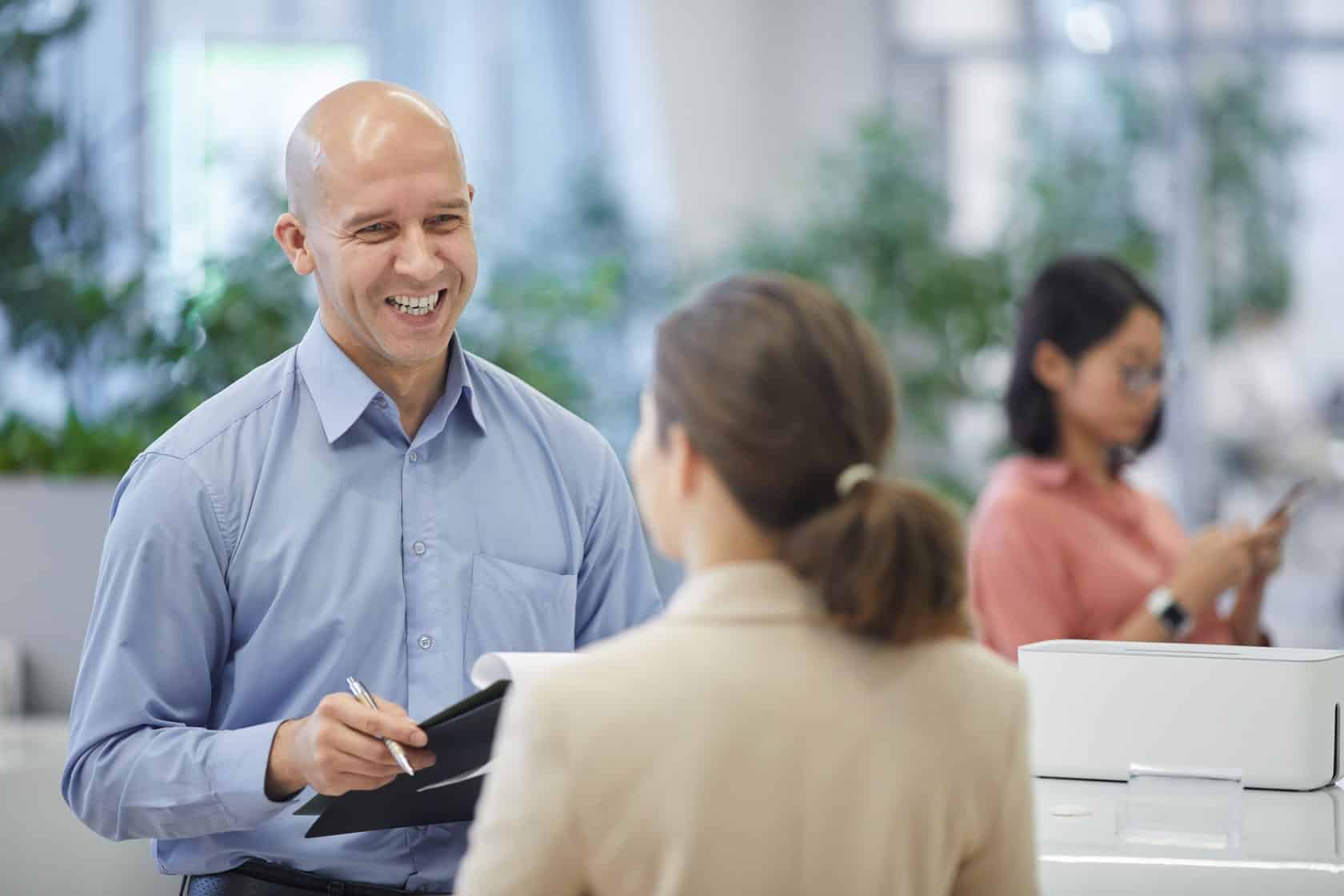 Colleagues discussing plans in an office